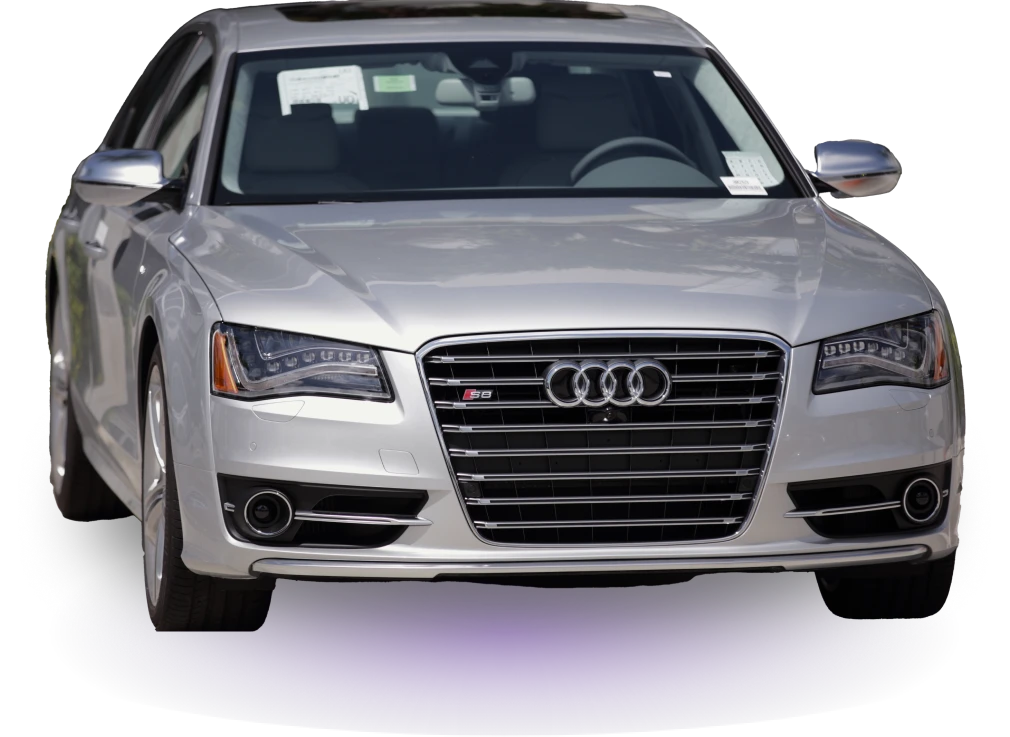 Front view of a sleek silver Audi S8 sedan with distinctive grille and LED headlights, set against a black background, exuding a luxurious feel.