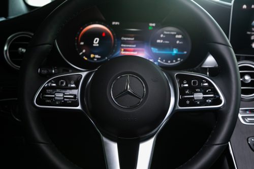Mercedes Repair and Maintenance in Rockville, MD at MB Automotive Services. Image of Mercedes-Benz GLC-class interior with the steering wheel featuring the iconic red logo and speedometer.